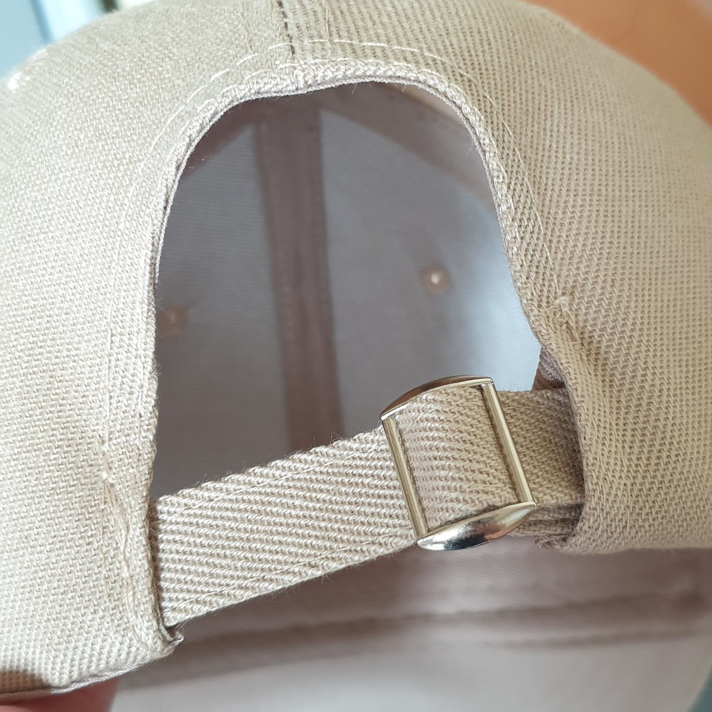 Adjustable beige cap cross drop